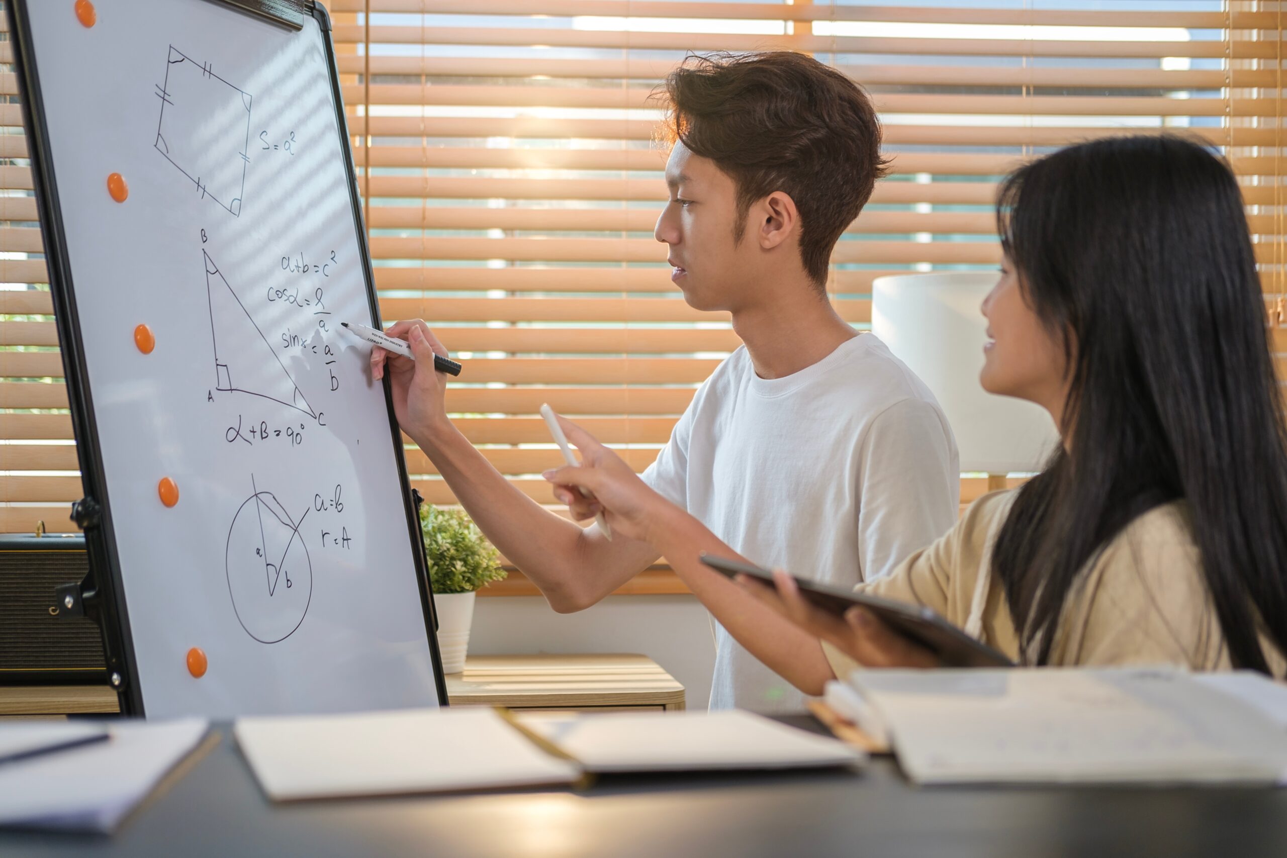 Students studying math on whiteboard